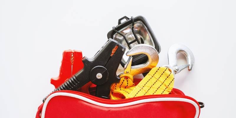A red bag filled with various tools and items.