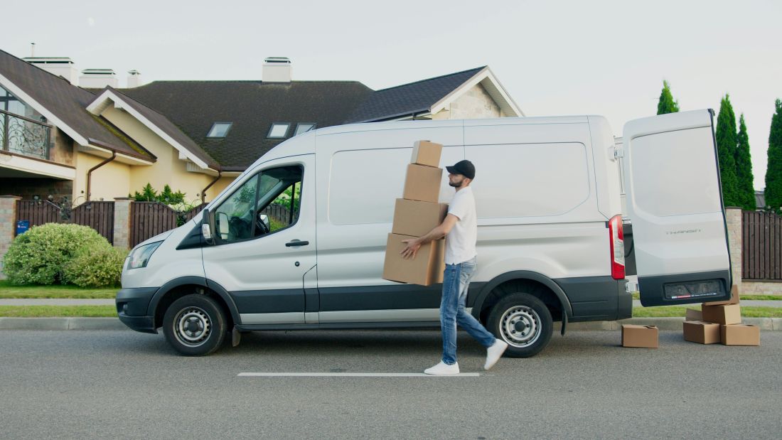 Person unloading parcels from a Van