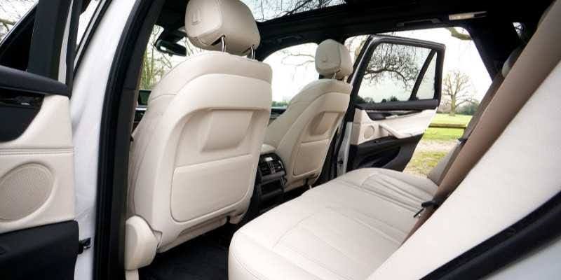 Interior of a white car featuring luxurious leather seats, showcasing a clean and modern design.
