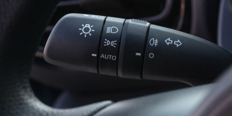 Close-up view of a car's steering wheel and indicator.