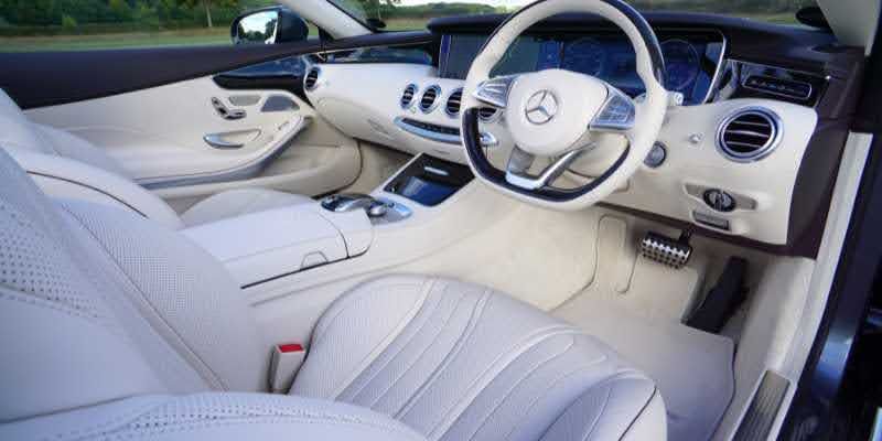 The luxurious interior of a Mercedes S-Class car, featuring premium materials and advanced technology.