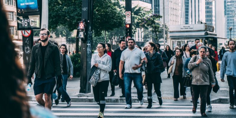 Pedestrians walking on a bustling city street.