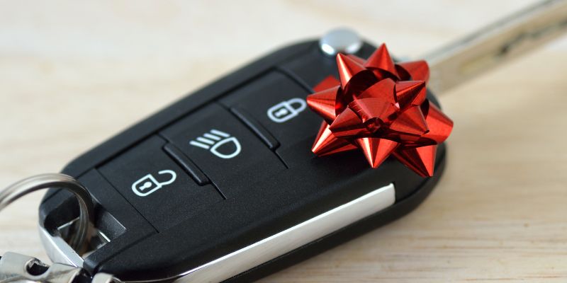 A set of car keys with a ribbon on them 