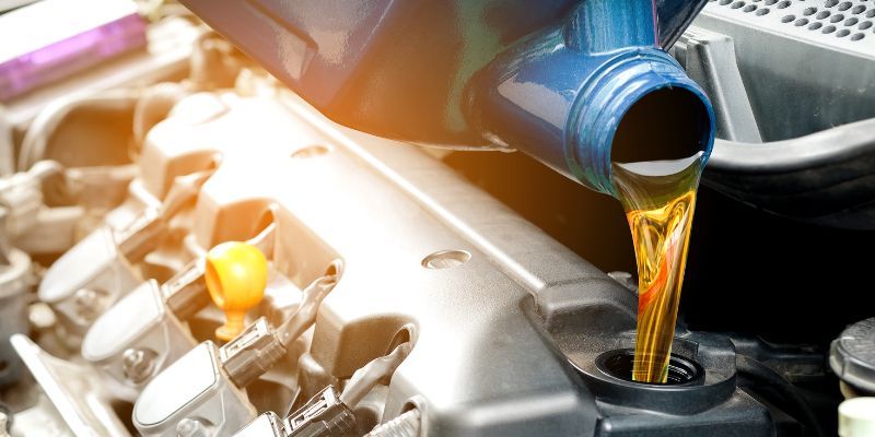 A car engine being filled with oil.