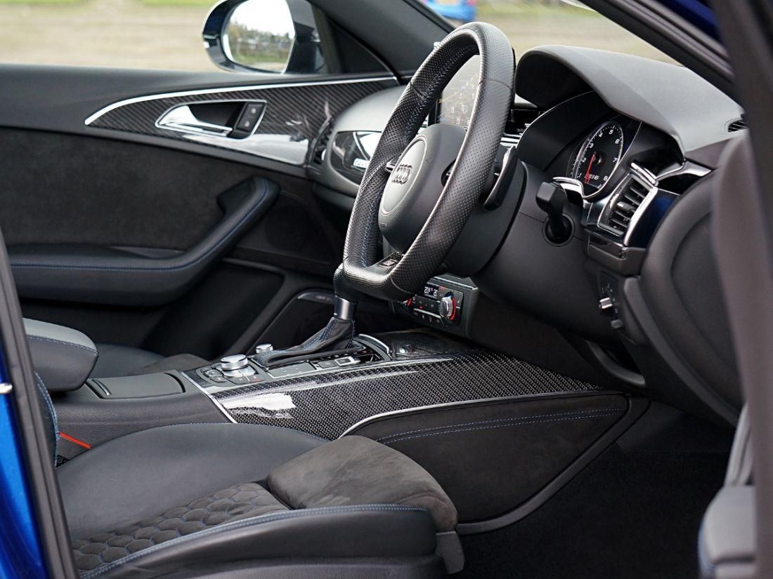Interior of an Audi from the angle of the drivers window, showing the seats, steering wheel and dashboard