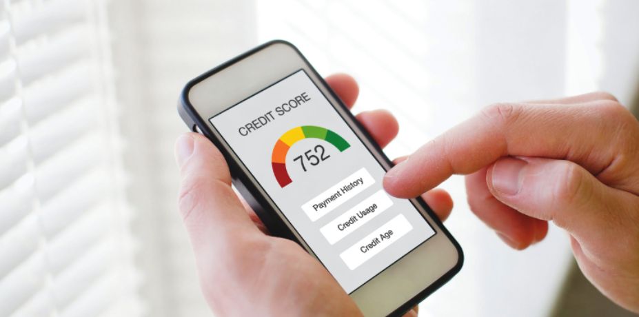 Person checking their credit score with a credit score gauge and related options displayed on the screen.