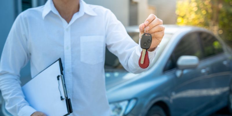 Person handing over car keys