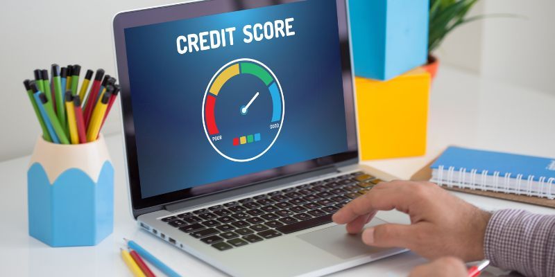 A laptop displaying a credit score indicator on its screen.