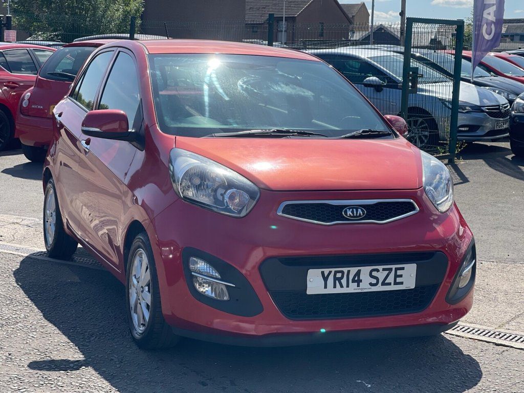 A red Kia Picanto parked outside of Cars 4 You