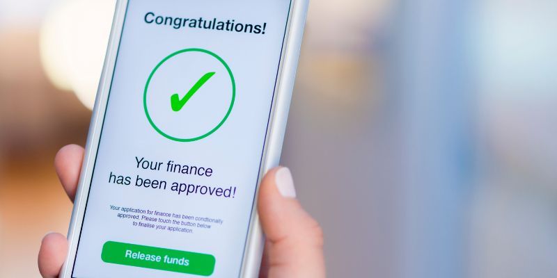 Smartphone displaying "Finance Approved" notification.