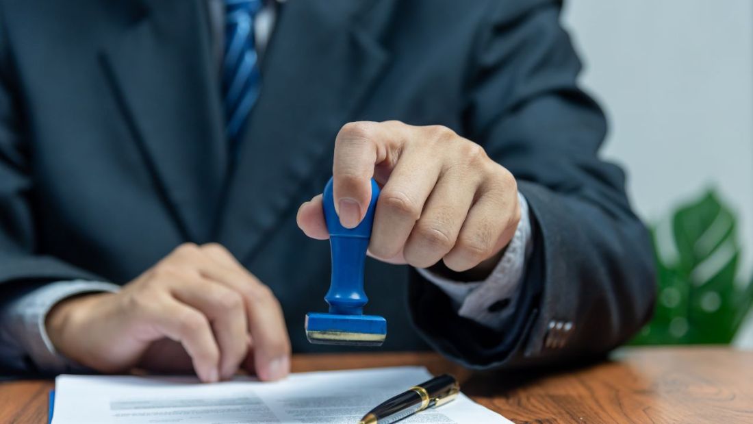 Someone in a Suit Stamping an Application