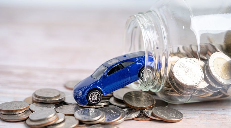A blue car falling out a pot of money