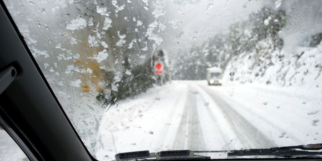 snowy road through windscreen