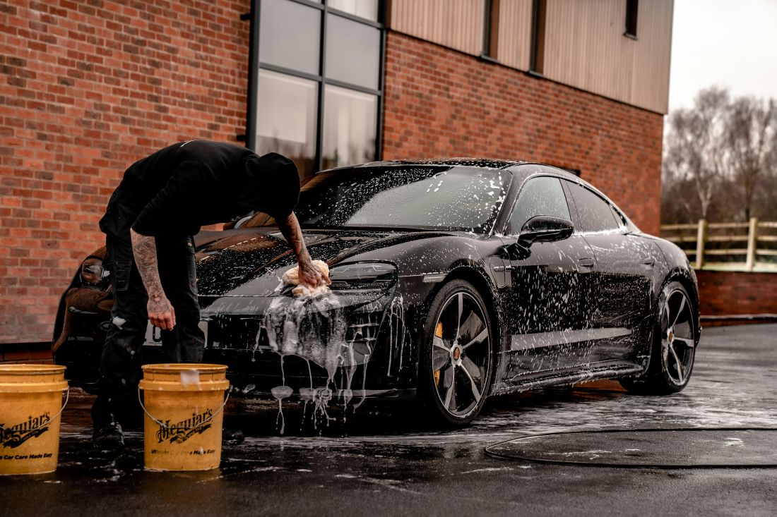 man washing car
