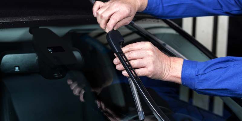 Someone changing windscreen wipers