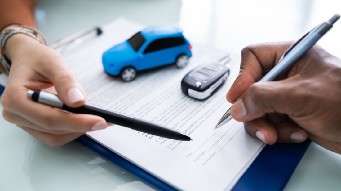 A Blue Toy Car On a Clipboard