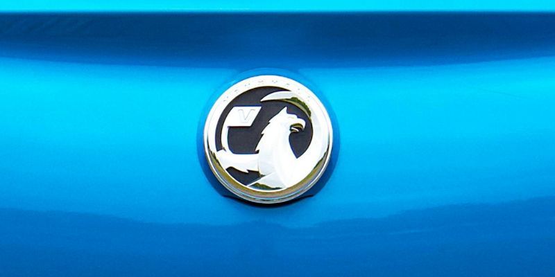 A Vauxhall badge on a blue vehicle. 