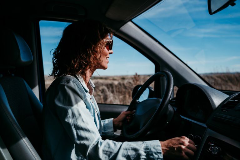woman driving an electric car on the road