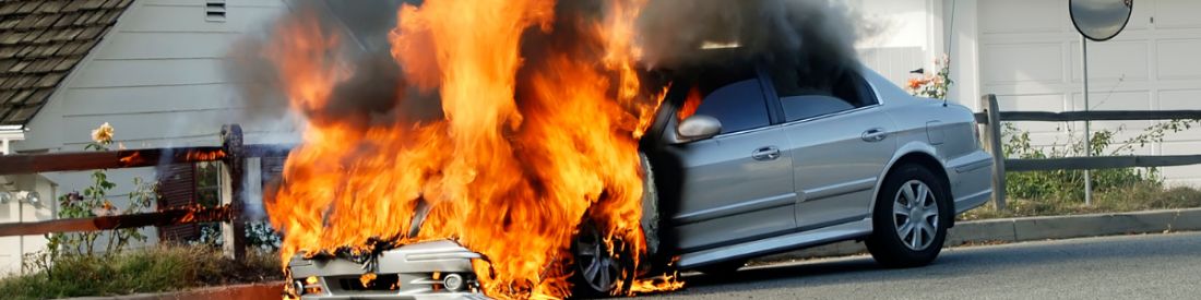 Silver car caught on fire following a car accident.