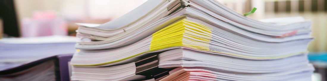 Stack of documents symbolising paperwork required for self-employed car finance applications.
