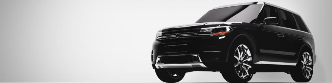 A Black SUV photographed showing its front and side, with blacked out windows