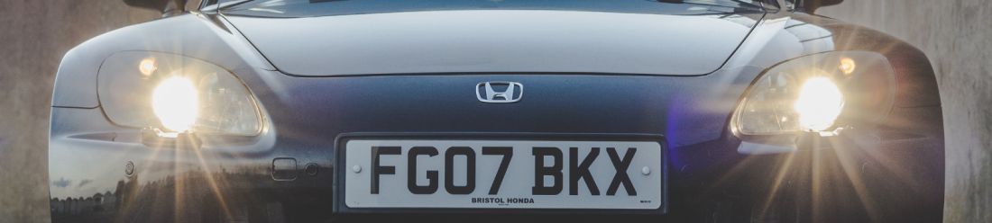 A Hyundai car facing front on with two glowing headlights