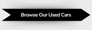 Black ribbon-shaped button with white text that reads 'Browse Our Used Cars'
