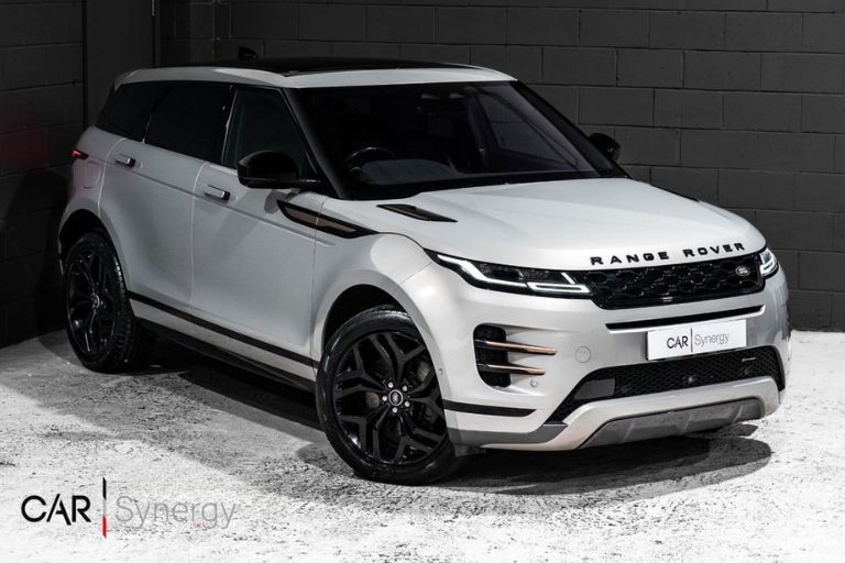 A white Land Rover Range Rover Evoque inside a car dealership