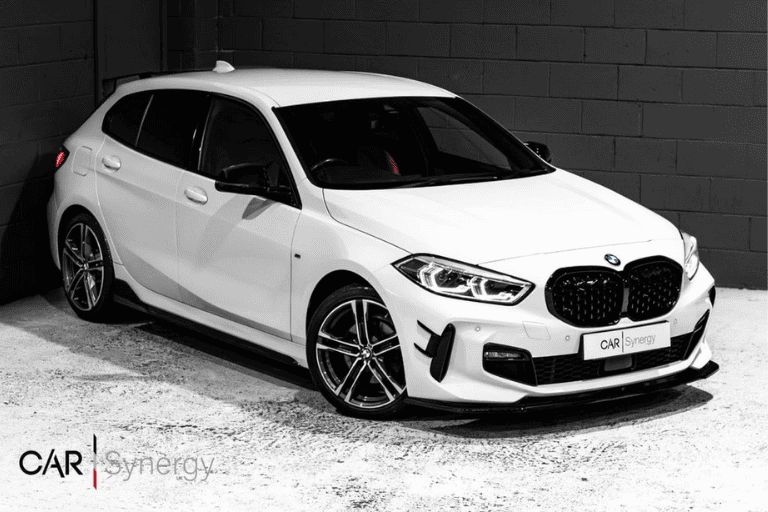 White BMW 1 series, inside a car dealership.