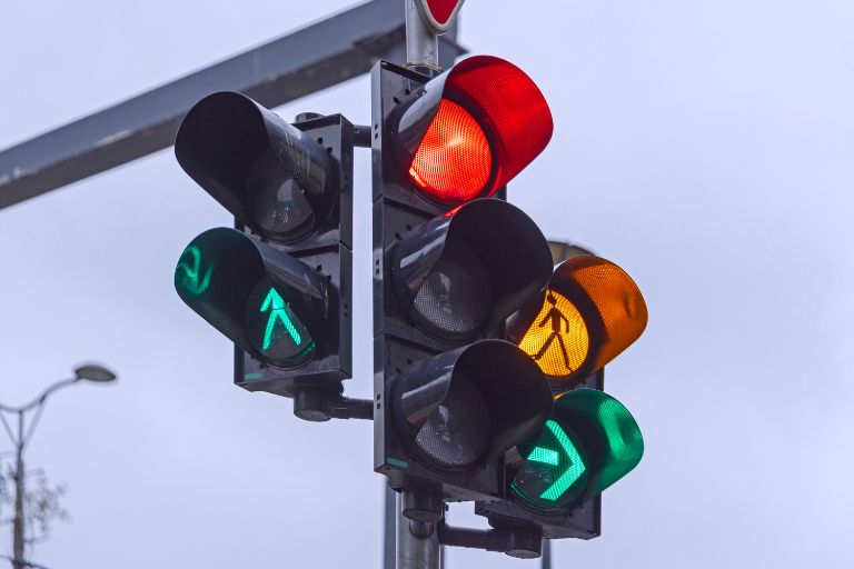 three traffic lights showing red and green