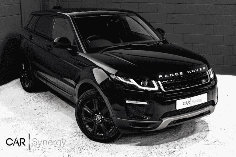Black Range Rover Evoque inside a car dealer showroom.