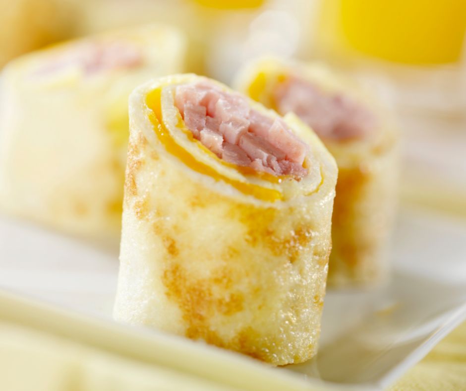 A close-up on a selection of ham and cheese wraps. 