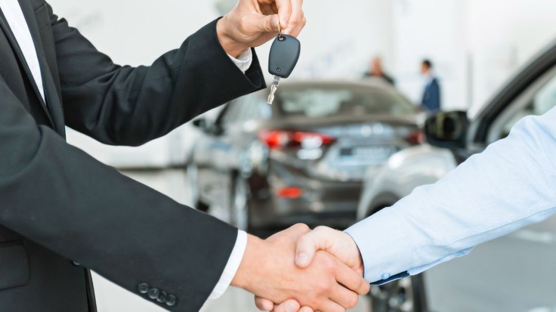 Two People Shaking Hands, Passing on Keys