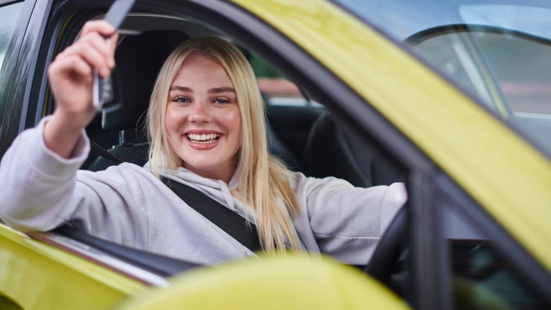 A New Driver Holding Keys in A Car