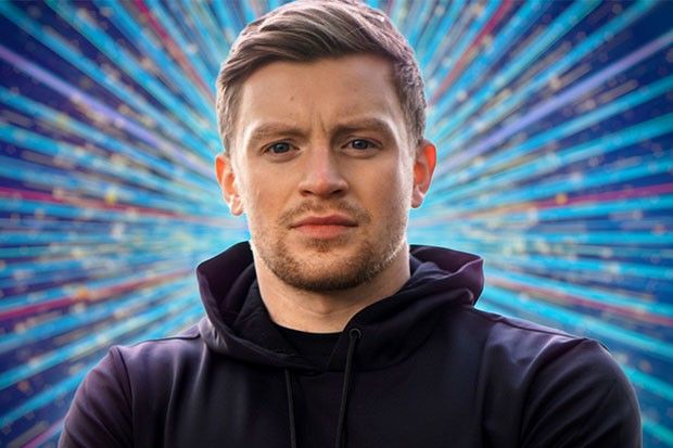 Adam Peaty in front of a firework style background. His arms are folded and he's looking directly at the camera.