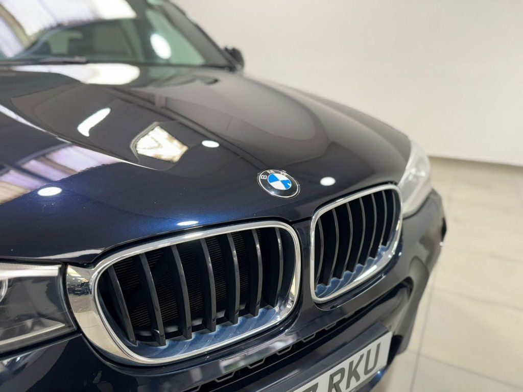 BMW X3 parked in a showroom, showcasing its sleek design and luxury features