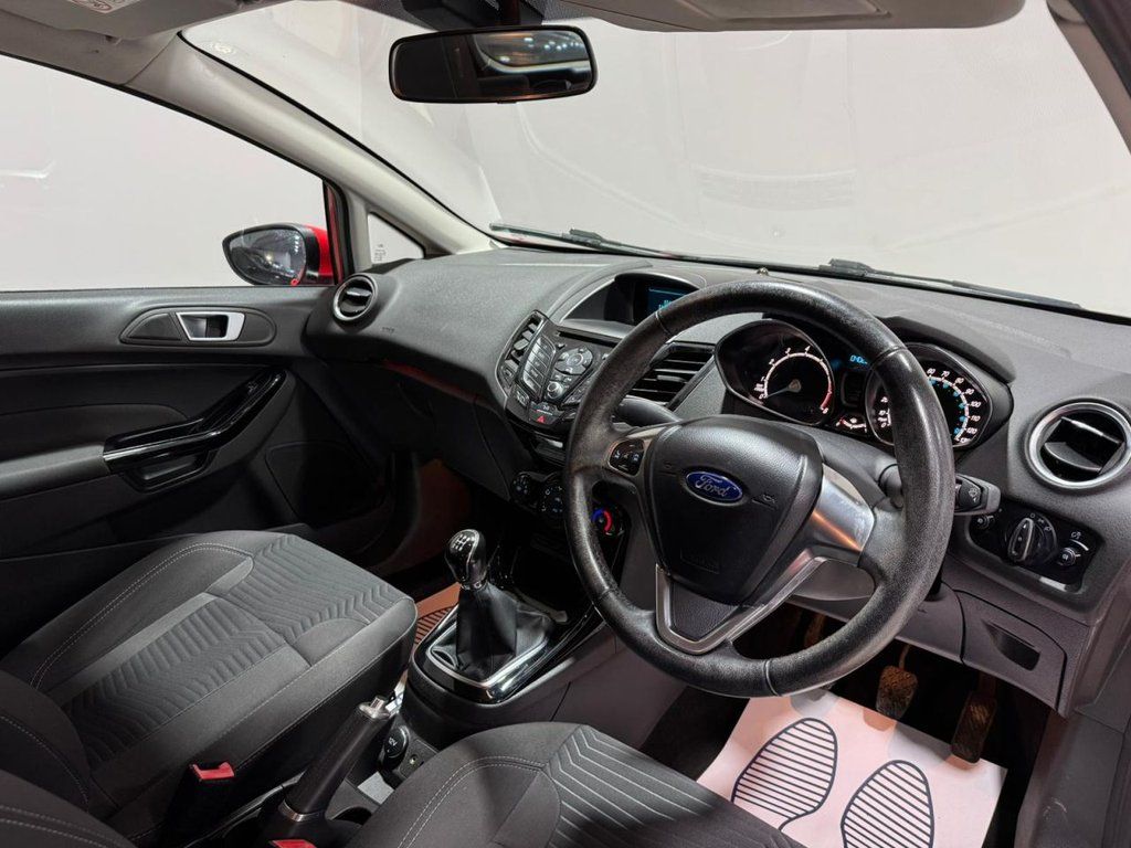 Interior view of a Ford Fiesta, showcasing the dashboard and seating arrangement.