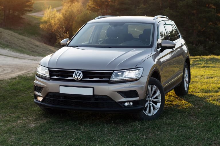 grey volkswagen tiguan parked on field