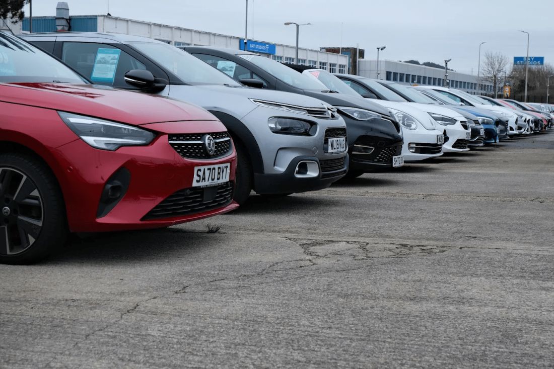 Outside the Corner Park dealership we see a range of used cars for sale