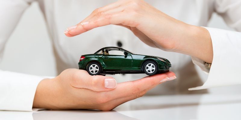 A Toy Car Being Protected By A Womans Hands