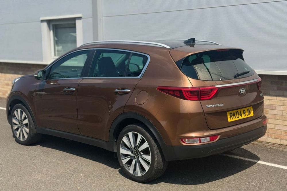 Bronze Kia Sportage 3 diesel crossover with panoramic roof parked for sale at Mersea Cars Colchester Essex
