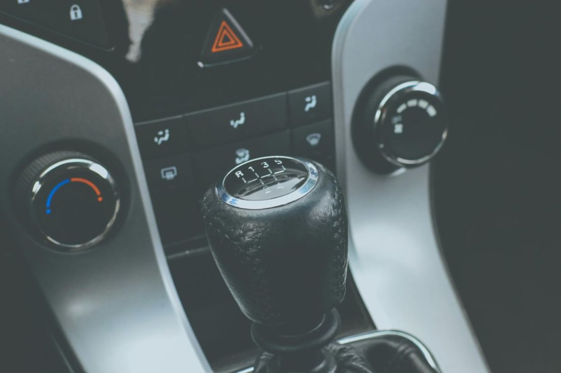 A close-up view of a car's gear stick, showcasing its design and texture in detail.