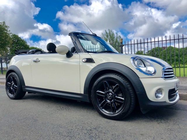 White MINI Cooper convertible with black alloy wheels.