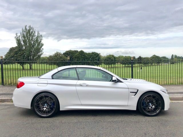 BMW coupe parked outdoors, side profile.