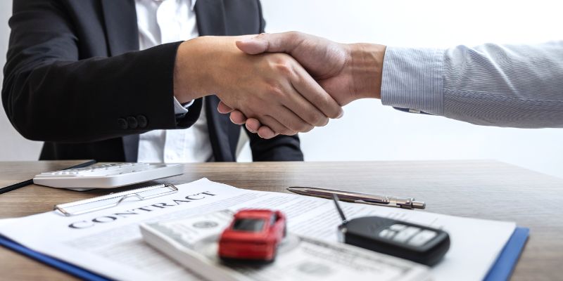A close-up of two hands shaking, for the finalisation of a car finance agreement.