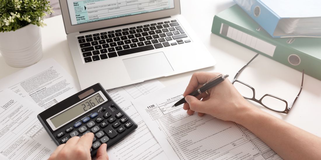 desk, calculator and laptop