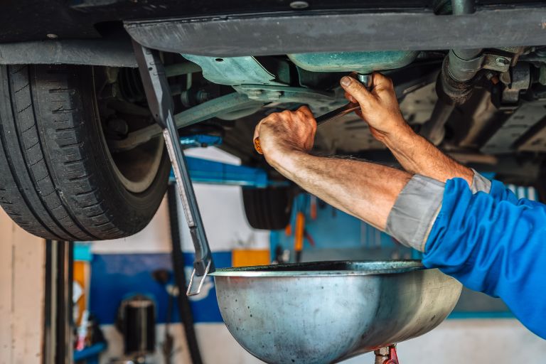a man completing a service on a car