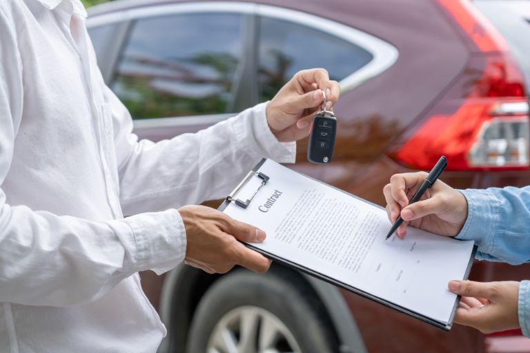 Somebody signing a car finance contract