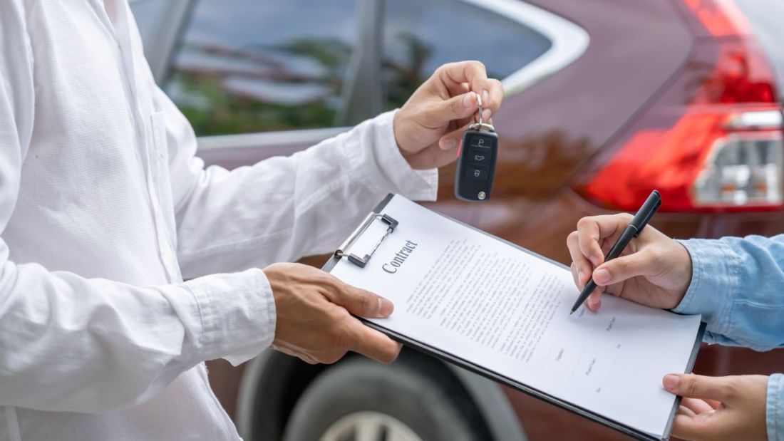A Contract Being Signed for Car Keys