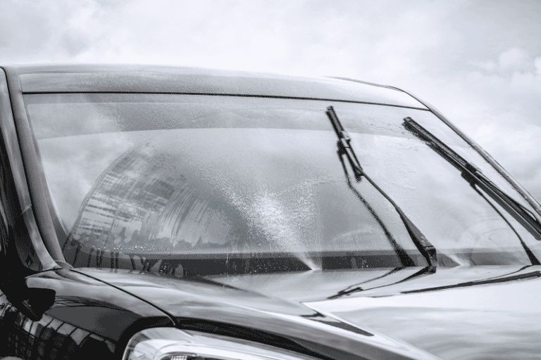 windscreen wiper blades cleaning a cars window